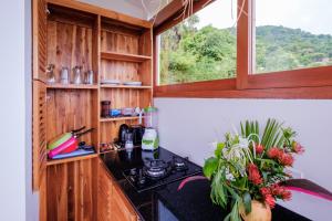 a kitchen with a stove and a window at Bukit Adi in Amed
