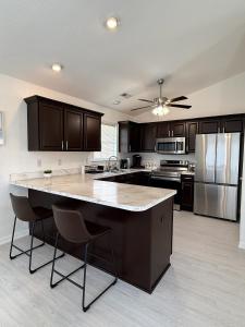 a kitchen with a large island in the middle at __Kristian’s Palace Your Beach Getaway in Kill Devil Hills