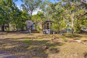 a house in the middle of a yard at Wattletree Cottage Halls Gap in Halls Gap