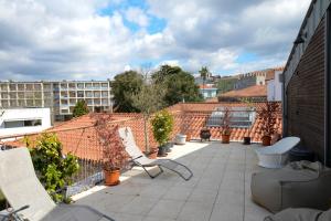 a balcony with chairs and plants on a building at Casa Matriz Séc. XVI | Double or Twin w/ balcony in Penafiel