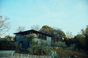 a house on a hill with a white fence at Hiire IZU OLIVE in Ito