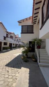 a courtyard of a house with stairs and potted plants at 10 Caribe, tranquilidad y Casa Familiar in Rodadero