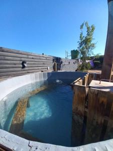 a large pool of water in a building at Cabaña Rústica en Papudo in Papudo