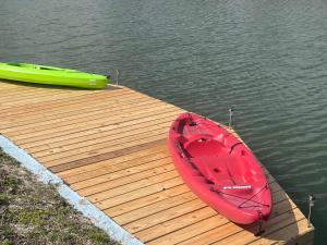 a red boat sitting on top of a wooden dock at Mia Rose in South Daytona
