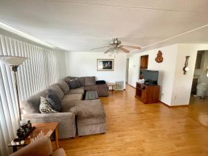 a living room with a couch and a television at Mia Rose in South Daytona