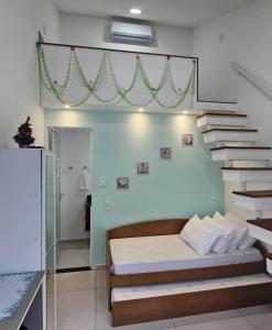 a bedroom with a bed and a stair case at Pousada Bahamas Sc in Penha +48 photos