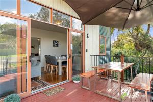 an open patio with a table and an umbrella at Phillip Island Resort Villa 148 Amazing Views in Cowes