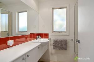 a white bathroom with a sink and a shower at Phillip Island Resort Villa 148 Amazing Views in Cowes +51 photos