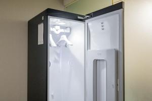 a white refrigerator in a corner of a room at Bulgwang 3S Hotel in Seoul +68 photos