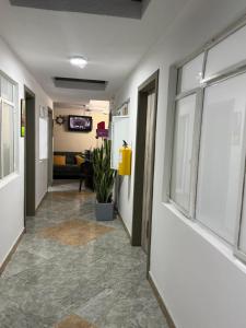 a hallway with a room with a couch and windows at CASA HOTEL VICTORIA Av 30 in Bogotá +1 photo