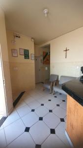 a room with a room with a cross on the wall at Norte Minas Hotel in Bocaiúva