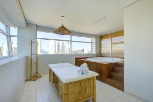 a bathroom with a tub and a sink and a window at Park Inn by Radisson Berrini in São Paulo +59 photos