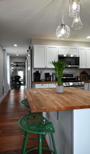 a kitchen with a wooden counter and a green stool at Ottawa Family Nest in Ottawa