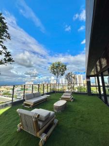three chaise lounges on the grass on a building at Flat Exclusivo com Rooftop e Piscina in Campina Grande