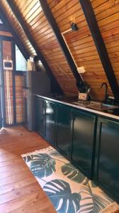 a kitchen with a sink and a counter top at Cumbre Verde Alpine Villa in Monción