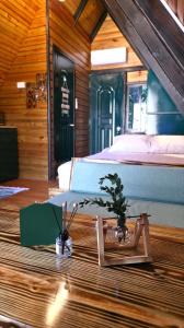 a bedroom with a large bed and two potted plants at Cumbre Verde Alpine Villa in Monción