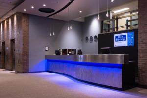 a lobby with a reception desk with blue lighting at Travelodge by Wyndham Montreal Centre in Montréal