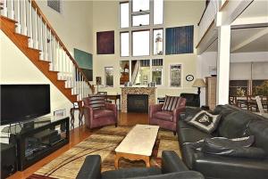a living room with a couch and a tv at Gem-By-The-Sea in Cape May Point