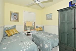 a bedroom with two beds and a ceiling fan at Gem-By-The-Sea in Cape May Point