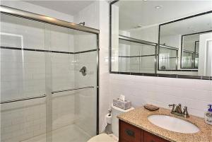 a bathroom with a shower and a toilet and a sink at Gem-By-The-Sea in Cape May Point +20 photos