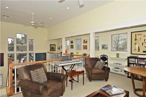 a living room with two chairs and a piano at Gem-By-The-Sea in Cape May Point