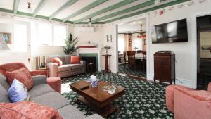 a living room with a couch and a table at Saltwood House in Cape May