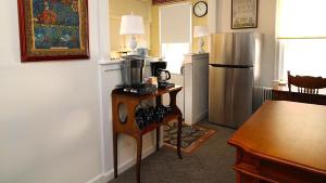 a kitchen with a refrigerator and a table with a microwave at Saltwood House in Cape May