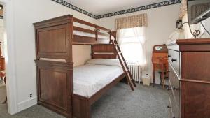 a bedroom with a bunk bed with a ladder at Saltwood House in Cape May