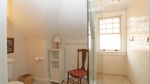 a glass shower in a bathroom with a chair at Saltwood House in Cape May +31 photos