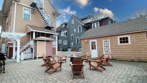 a patio with chairs and a table and a building at Saltwood House in Cape May