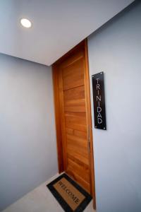 a room with a wooden door with a sign on it at Avaya Oasis - Villa Trinidad in Carenage +37 photos