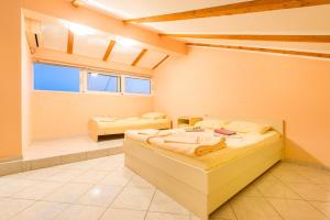 a large room with two beds and a bathroom at Vila Vukotić in Petrovac na Moru