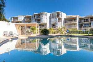 a large apartment building with a pool in front of it at Surfside Buddina Beachfront 3bed Apt - Direct Beach Access in Buddina