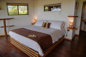 a bedroom with a large bed in a room at Kona Koa Lodge in Hanga Roa