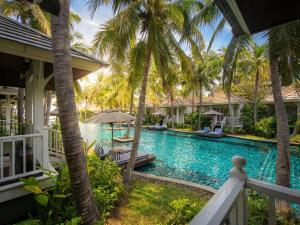 a view of a resort pool with palm trees at Rest Detail Hotel Hua Hin in Hua Hin