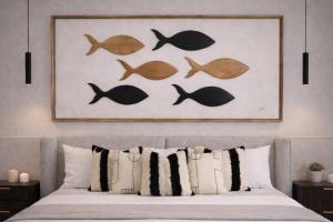 a bedroom with a bed with fish on the wall at Garden Atelier - Private Cenote & Steps from the Beach in Tulum