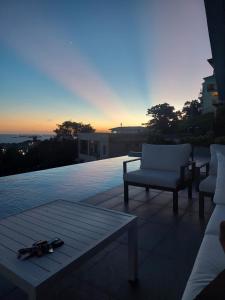 a patio with two chairs and a pair of scissors at Avaya Oasis - Suriname Suite in Carenage +35 photos