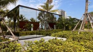 a museum with two metal structures in a park at Mirror Mirror Hotel Cafe & Restaurant in Ban Hang Ta Duk