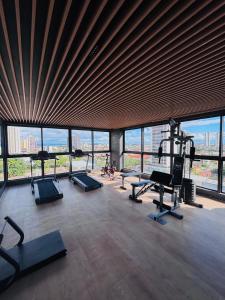 a gym with treadmills and machines in a building at Flat Exclusivo com Rooftop e Piscina in Campina Grande