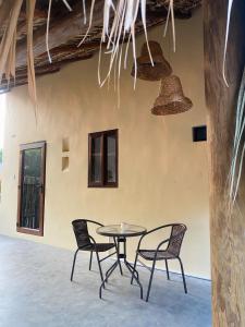 a table and chairs in front of a building at Calypso Loft in El Paredón Buena Vista
