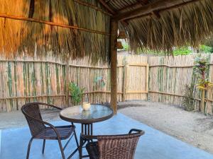 a patio with a table and chairs and a fence at Calypso Loft in El Paredón Buena Vista