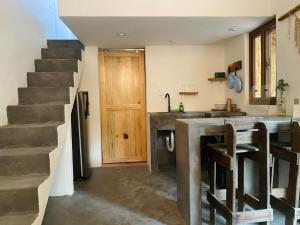 a kitchen with a counter and a sink and a staircase at Calypso Loft in El Paredón Buena Vista