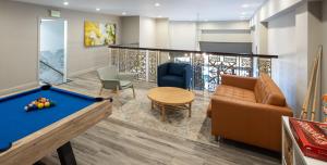 a room with a pool table and a couch at Oaktown Roost in Oakland