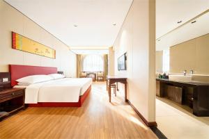 a hotel room with a bed and a sink at 济南璞秀酒店-山东师范大学千佛山店Cultural Experience Hotel in Jinan