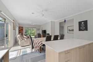 a kitchen and dining room with a table and chairs at The Buckleys Escape in Point Lonsdale
