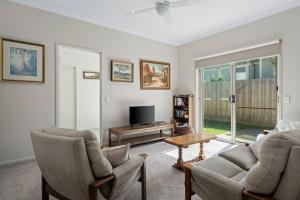 a living room with two chairs and a tv at The Buckleys Escape in Point Lonsdale