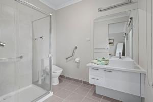 a bathroom with a shower and a sink and a toilet at The Buckleys Escape in Point Lonsdale +8 photos