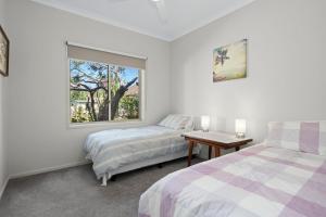 a bedroom with two beds and a window at The Buckleys Escape in Point Lonsdale