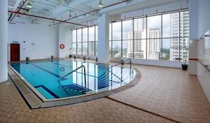 a large swimming pool in a building with windows at New York Hotel in Johor Bahru