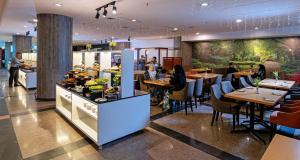 a restaurant with people sitting at tables and a buffet at New York Hotel in Johor Bahru